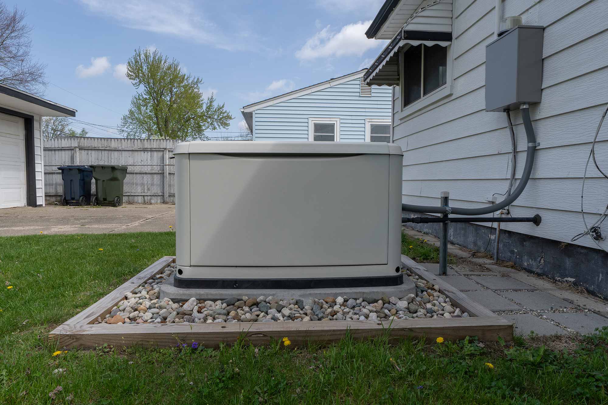 Whole-home standby generator installed beside a house