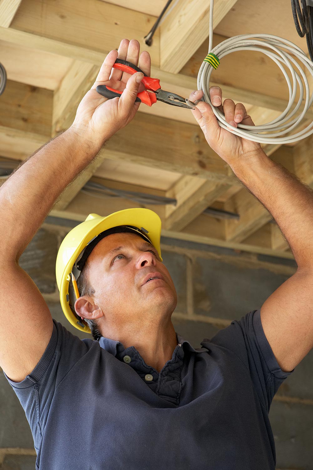 Electrician installing residential lighting wiring