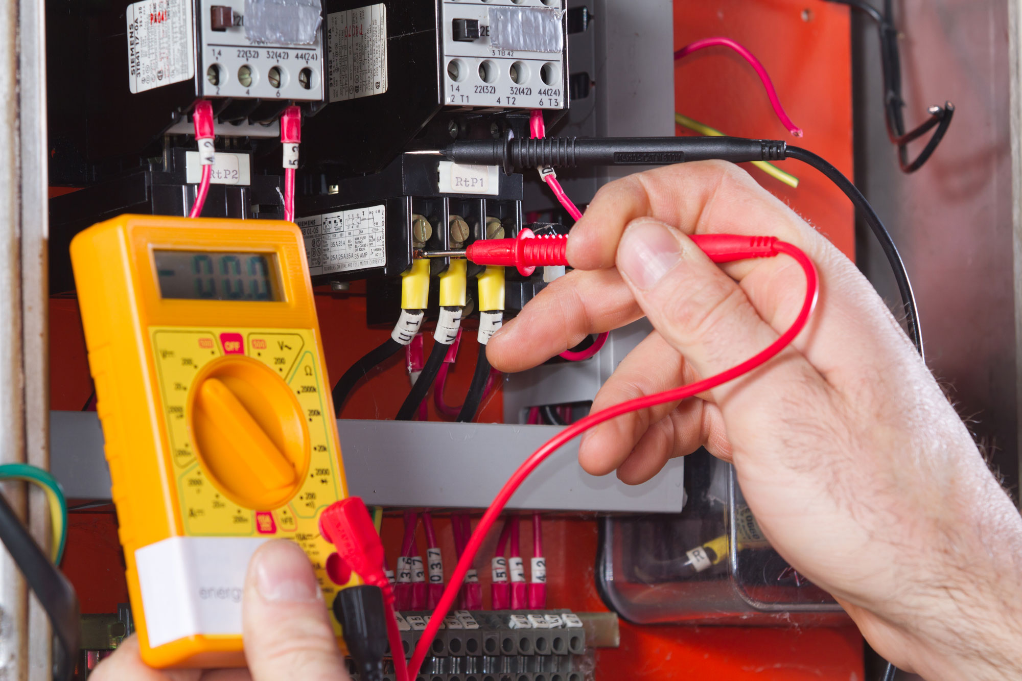 Electrician performing an electrical diagnostic test